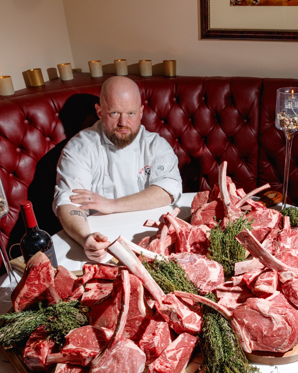 Chef with steaks on the table